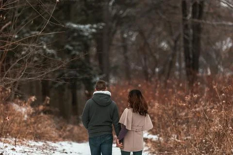 A   close   up   of   a   couple   strolling   through   winter Stock Photos