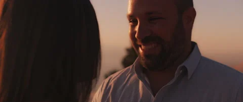 Close up of a couple talking and looking at each other with love at sunset Stock Footage 136243602