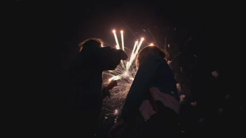 Close-up couples from the back, colorful night city salute Stock Footage 138742631