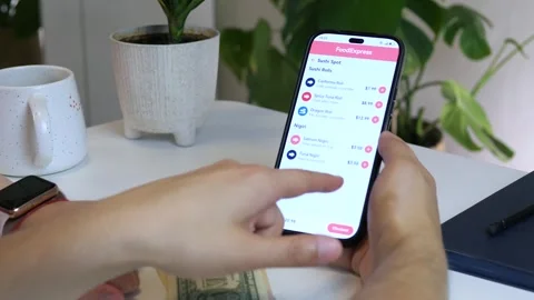 Close-up of a couples hands using a food delivery app to choose a meal together Stock Footage 315558300