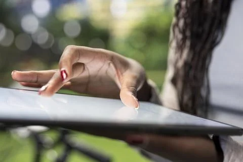 Close up of courier using fingers to navigate touchscreen tablet outdoors Stock Photos