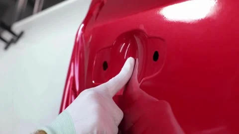 Close-Up of a Covered Car Door with Red Fabric Stock Footage 291543536