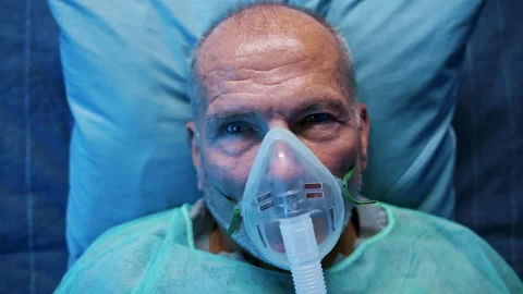 Close-up of covid-19 patient with oxygen mask in bed in hospital, coronavirus Stock Footage 144214367