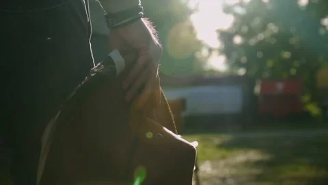 Close up of a cowboy hat and a man walking at sunset Stock Footage 146975334