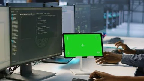 Close up of coworkers coding on chroma key device in data center Stock Photos