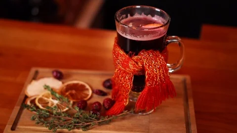 Close up cozy atmosphere mulled wine hot alcohol drink on wooden table in funny Stock Footage 103992548