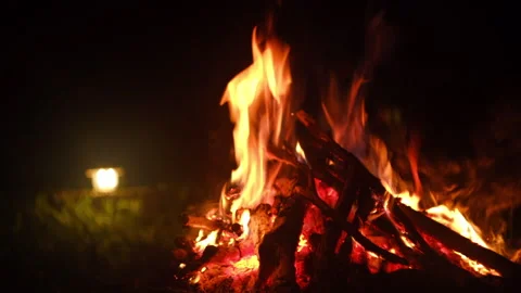 Close up of cozy campfire and light lantern at night. Bonfire, burning old wood Stock Footage 326881615