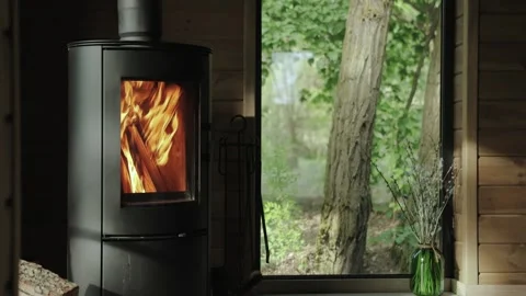 Close-up cozy house chimney fire place fire burning in a tiny house, wooden wall Stock Footage 253650702