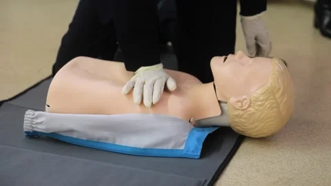 Close-Up of CPR Training on a Dummy with Chest Compressions Stock Footage 280010412