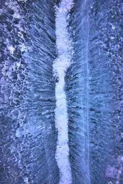 Close Up Crack and Snow Texture on Frozen Winter Lake Surface Stock Photos