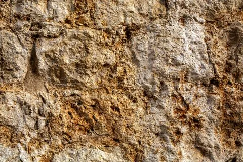 Close up of crack on rough stone wall for design Stock Photos