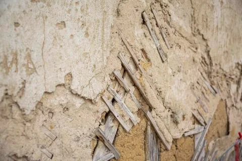 Close up of cracked adobe wall texture, clay wall from a mud house. 写真素材
