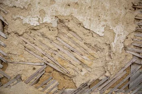 Close up of cracked adobe wall texture, clay wall from a mud house. 스톡 사진