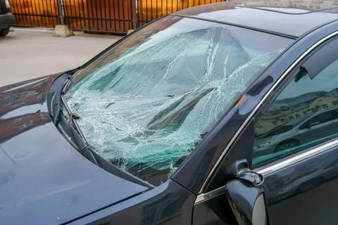 Close up of cracked car windshield after crash shattered glass and impact dam Фото