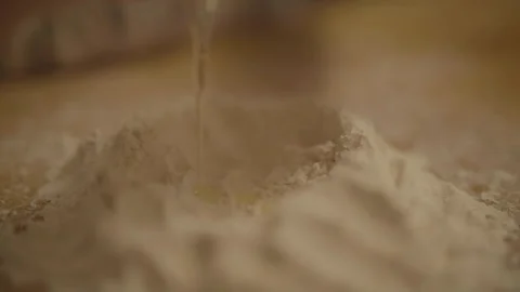 Close-up of cracked egg in flour well Stock Footage 336374783