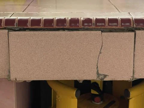 Close Up Of Cracked Pink Ceramic Tile With Messy DIY Repair Fix Stock Photos