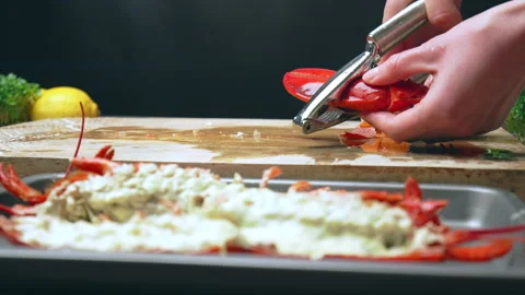Close-up of cracking cooked red lobster with seafood tool and Lobster Cracker. Video stock 146343492