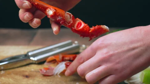 Close-up of cracking cooked red lobster with seafood tool and Lobster Cracker. Video stock 146343866