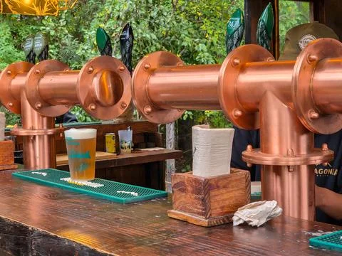 Close-up of craft tap, draft beer dispenser in brewery yard. Patagonia Brewery. Stock Photos