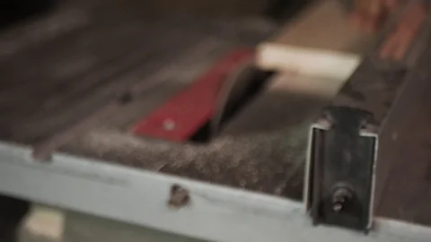 Close up. The craftman is working on electric saw machine. Sawing a board. Stockbeeldmateriaal 110339452