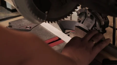 Close up. The craftman is working on electric saw machine. Sawing a board. Stockbeeldmateriaal 110674796