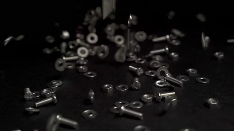 Close up crafts of bolts, screws, nuts, washers falling and bouncing. Stock Footage 219108580