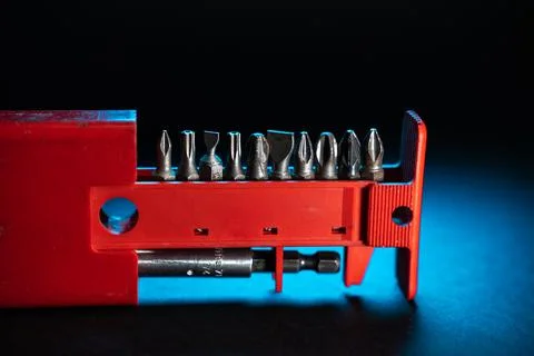 Close up crafts of screws. drill bits red package, blue light background Stock Photos