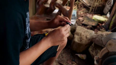 Close up craftsman attaching stick to gem stone 動画素材 87186510