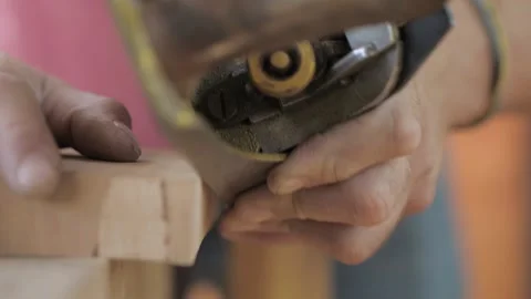 Close-up.craftsman carpenter whittles workpiece of wooden board with jack-pla Stock Footage 139446470