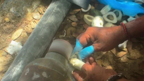 Close-up of craftsman hands shaping and polishing a seashell with an electric Stock Footage 337942214