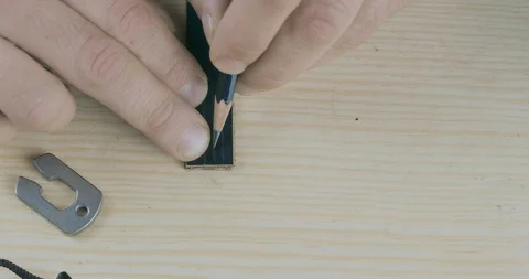 Close-Up Of A Craftsman's Hand Marking A Strip Of Leather With A Pencil Stock Footage 121588379