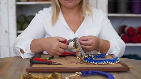 Close-up of craftswoman working and making handmade jewelery in workshop Video stock 130605799