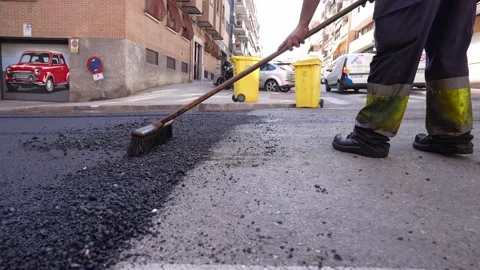 Close-up of crafty road worker treating warm mix asphalt 스톡 동영상 253230476