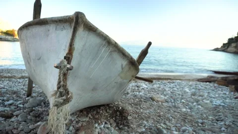 Close up crane 4K shot of old boat lying on shore Stock Footage 133200907