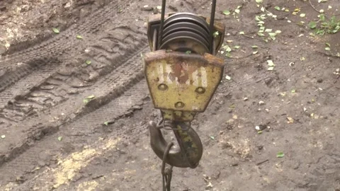 Close-up of a crane hook during operation against the backdrop of a construct Video stock 297210723
