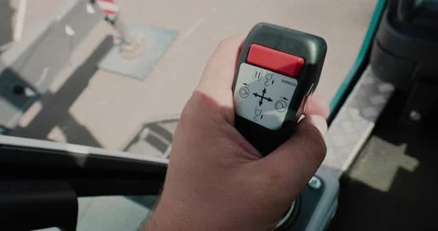Close-up of a crane operator's hand on a control lever in a truck crane cabin. Stock Footage 136854823