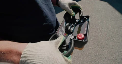 Close-up of a crane radio remote control panel in the hands of a crane operator. Stock Footage 136527236