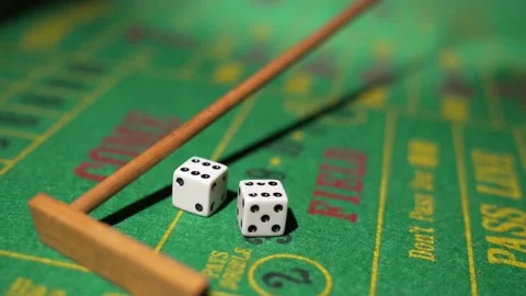 Close up craps dealer pulls back rolled dices Stock Footage 153951373