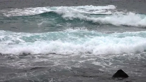 Close up of crashing waves on a beach in winter - Video HD Stock Footage 232990131