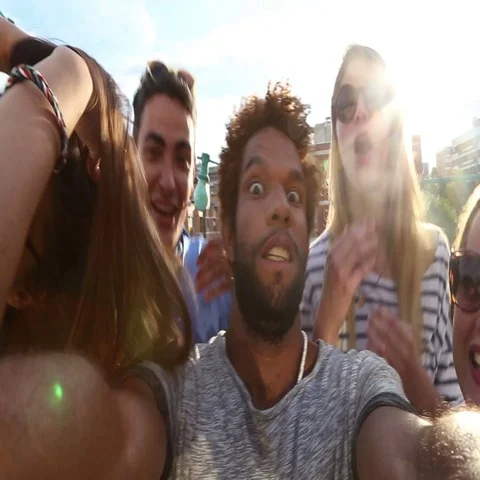 Close up of crazy group of friends filming themselves at rooftop party Stock Footage