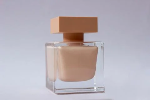 Close-up of cream-colored eau de Parfum. Close-up photo on a white background Stock Photos
