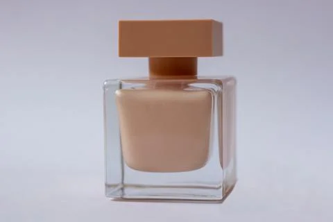 Close-up of cream-colored eau de Parfum. Close-up photo on a white background Stock Photos