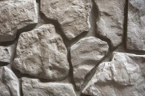 Close-Up of Cream Fieldstone Wall Texture with Irregular Natural Stone Patter Stock Photos
