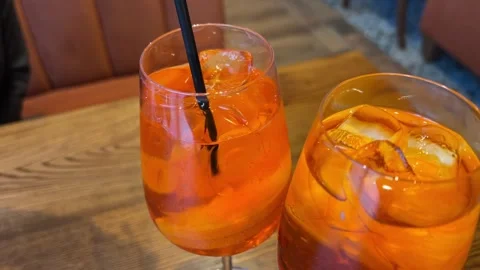 Close-up of the creation of a refreshing orange cocktail aperol spritz with ice Stock Footage 317808052
