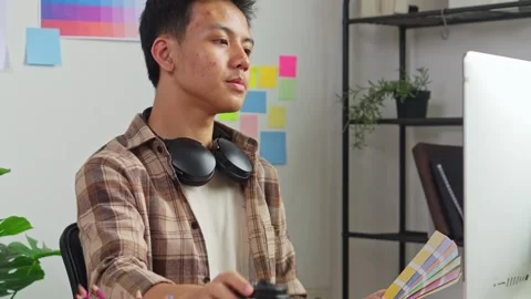 Close up of creative artist drinking coffee from coffee cup while drawing Stock Footage 336701242