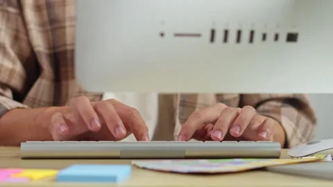 Close up of creative graphic designer typing on computer keyboard in modern Stock Footage 336703877