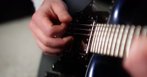 Close-up creative musician playing fingerpicking with on a blue electric guitar. Stock Footage 169642478