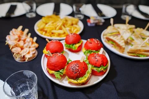 Close up of creative red mini slider burgers on a party buffet table tray Stock Photos