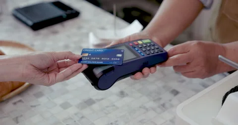 Close up of credit card being inserted into point of sale machine by customer Stock Footage 320523139