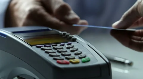 Close up of a credit card scanner processing a card and printing receipt Stock Footage